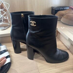 CHANEL Black Leather Heeled Boots with Gold Accent